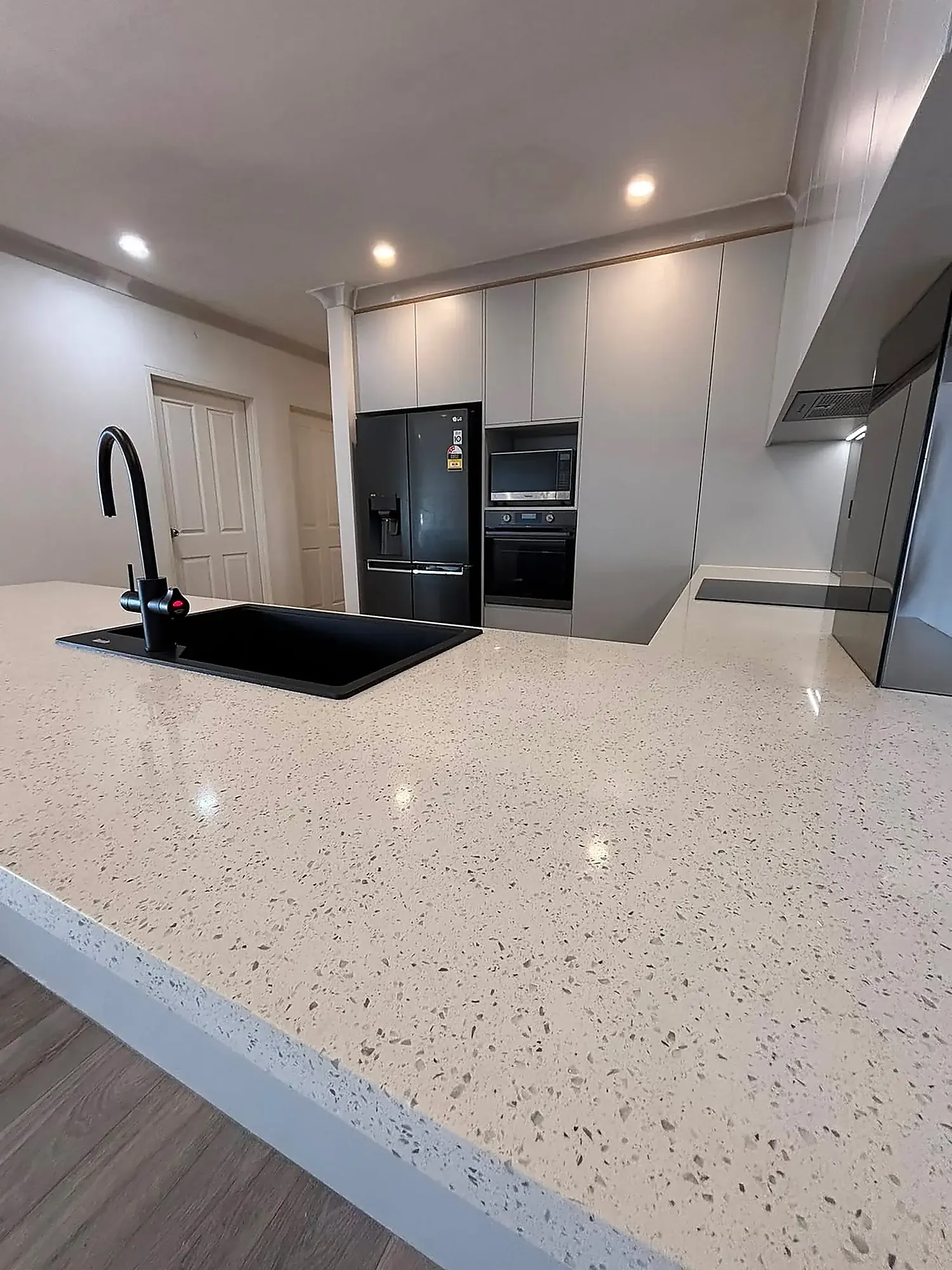 Speckled stone benchtop and waterfall return