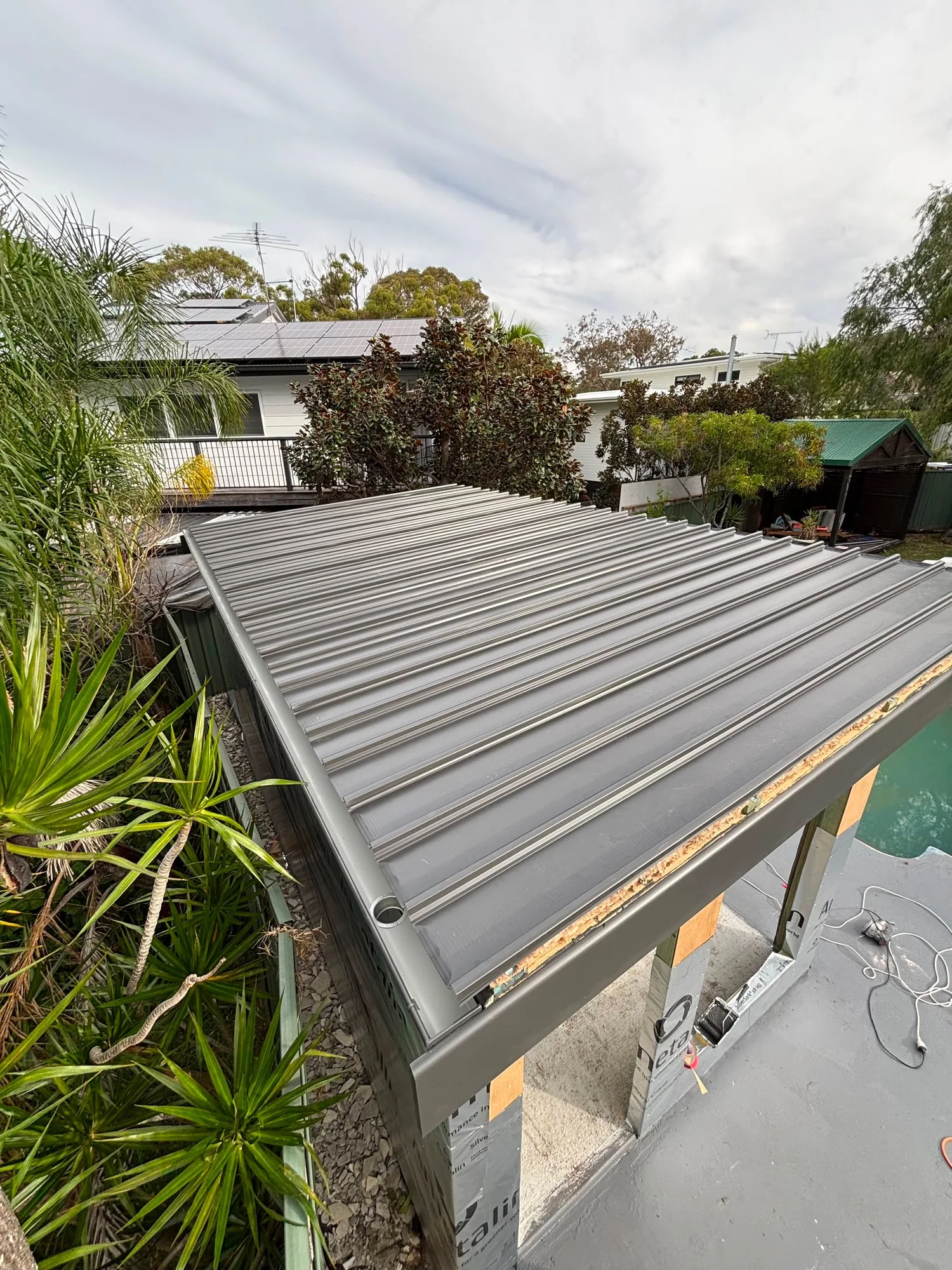 Roof sheeting and guttering going on at the Caringbah pool house